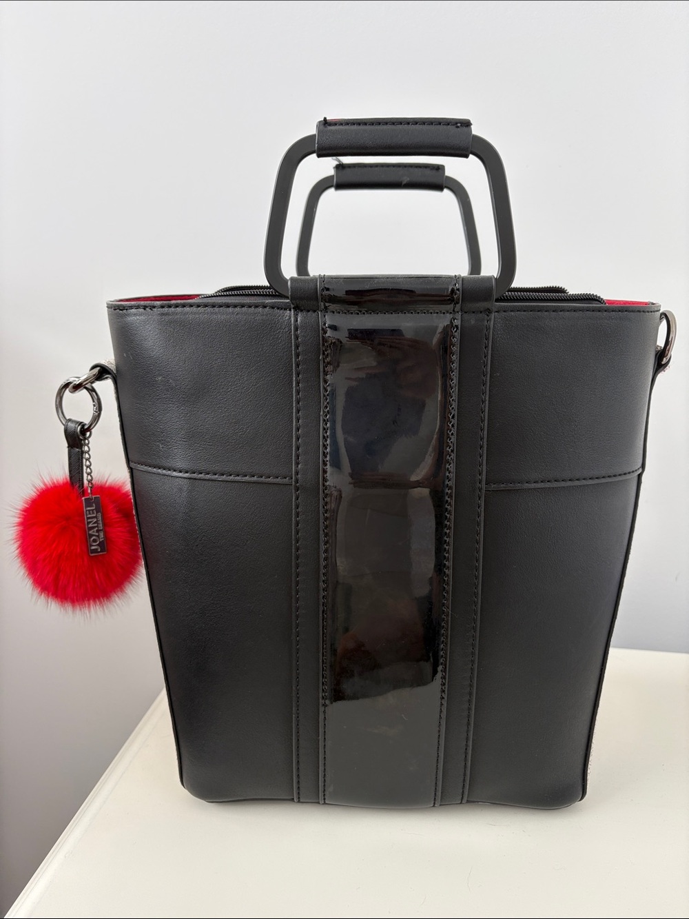 Black Structured Top-Handle Tote with Red Pom Accent